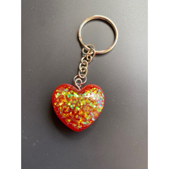 Porte-clé coeur rouge avec paillettes holographiques.